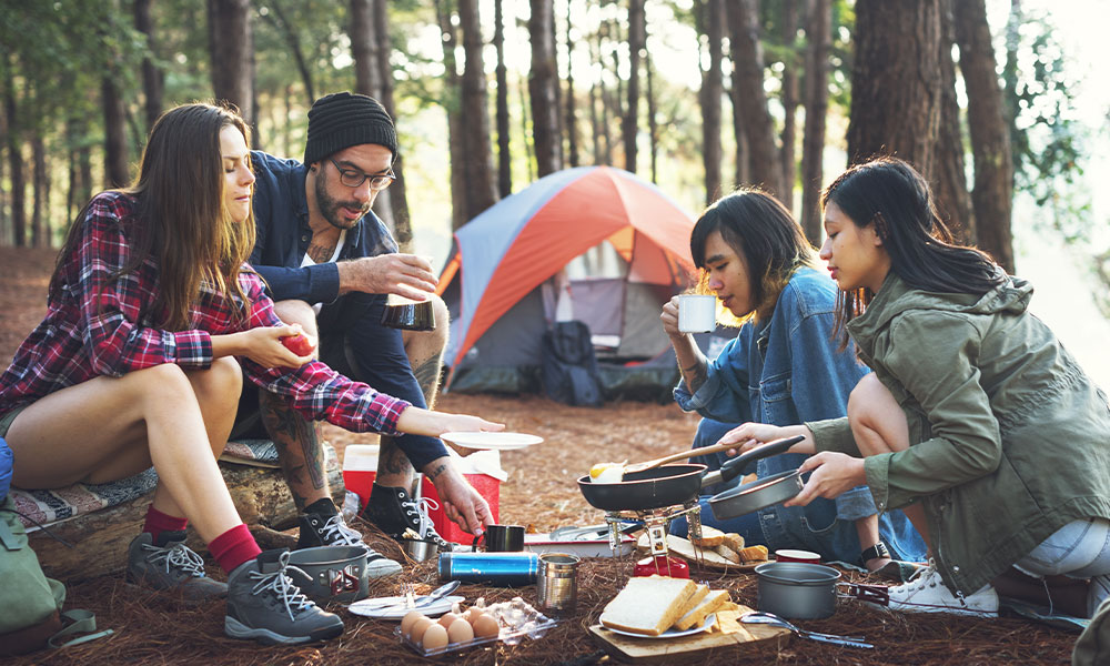 cooking campsite friends