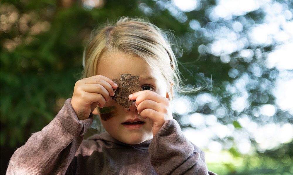 Girl looking at leaf&nbsp;