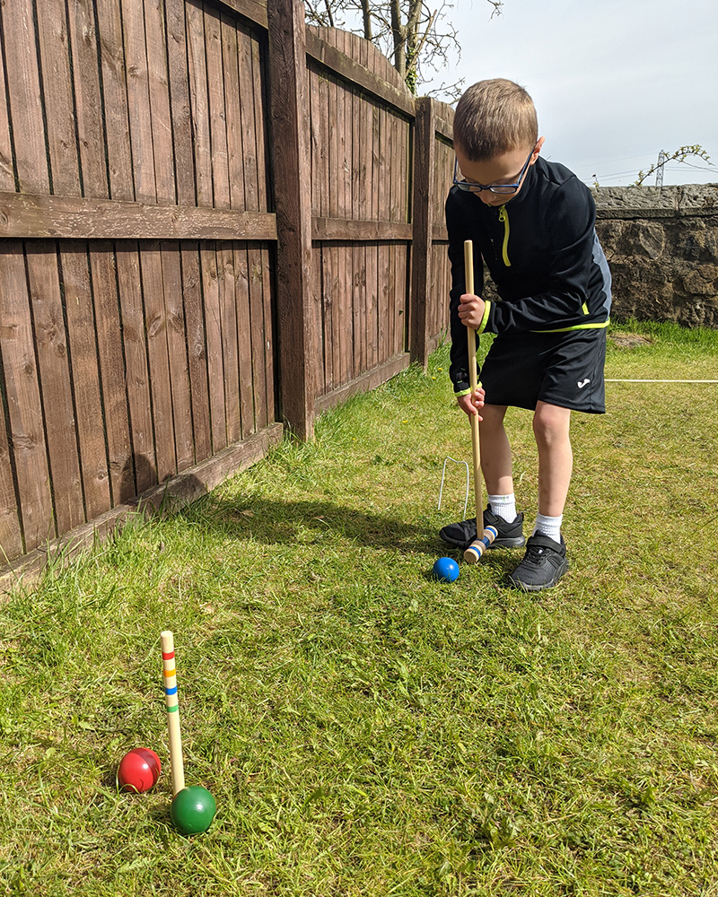 Child playing croquet