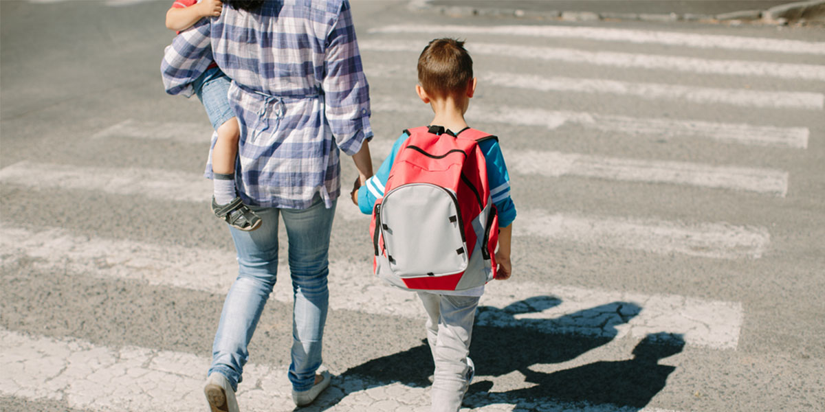 Child walking to school with mother