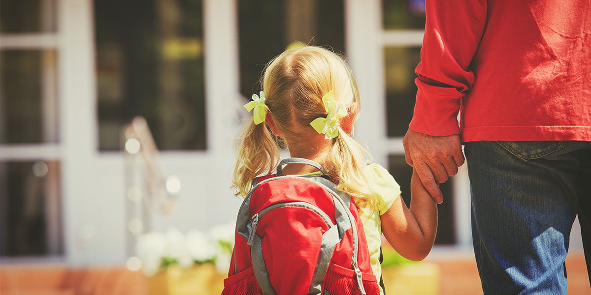Child walking to school with father