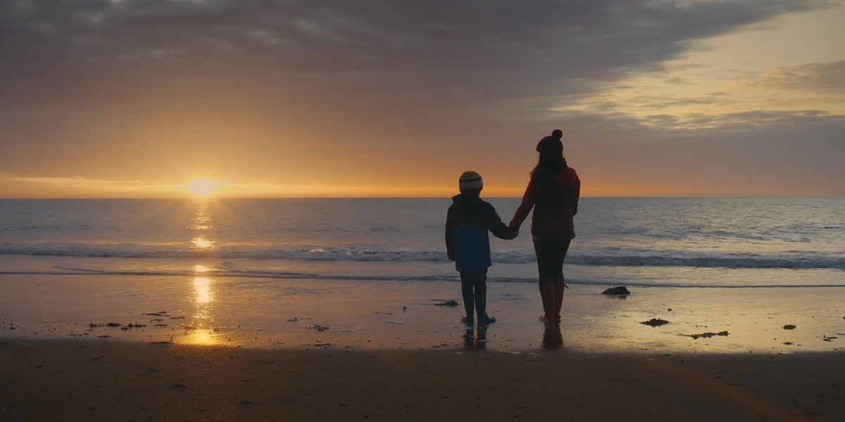 Laura at beach with son